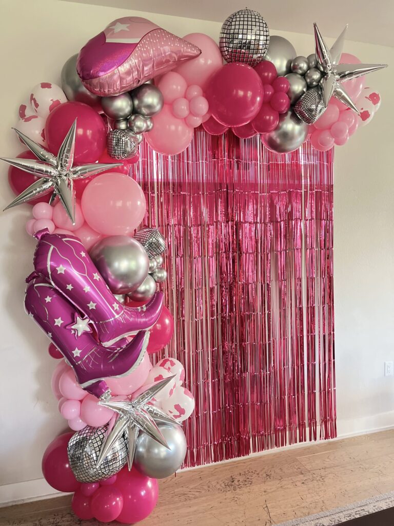 Hot pink and silver balloon garland with a disco ball and cowboy boot balloon in Austin, TX