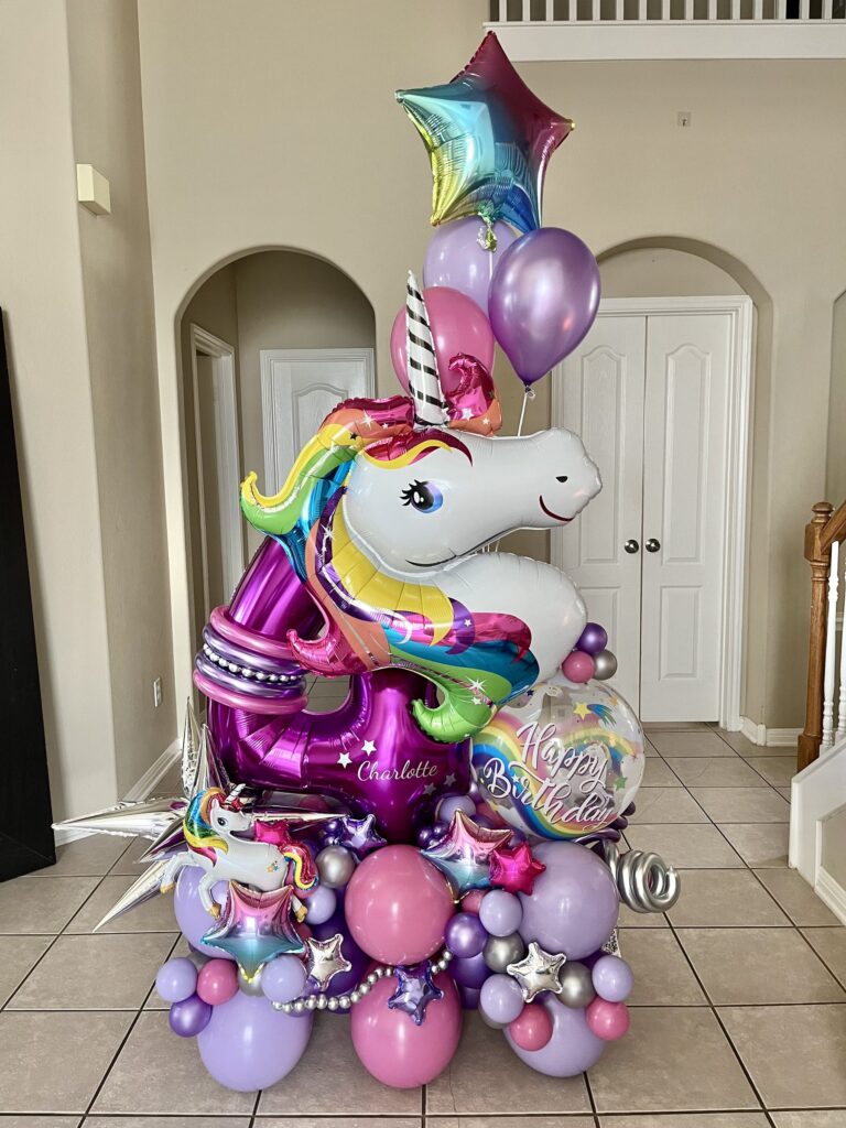 Pastel purple and pink unicorn themed balloon bouquet with a rainbow star balloon in Austin, TX