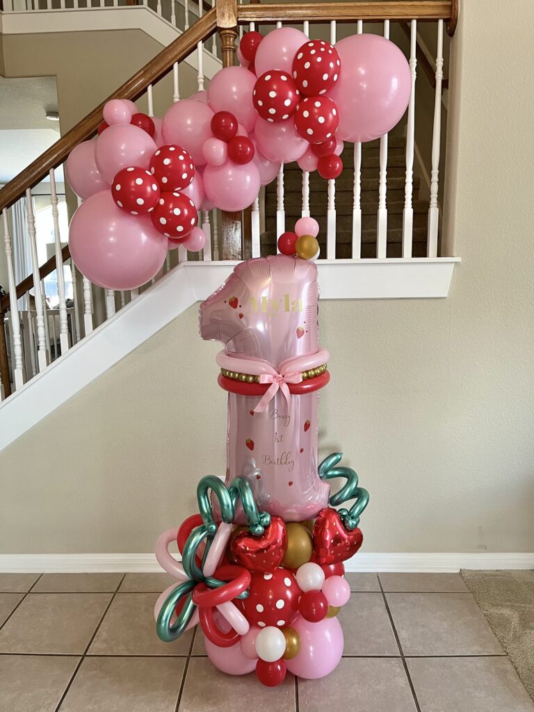 Red and pink Minnie Mouse themed balloon tower with a number 1 balloon in Austin, TX